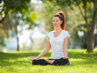 bigstock-Yoga-outdoor-Happy-woman-doin-172357406